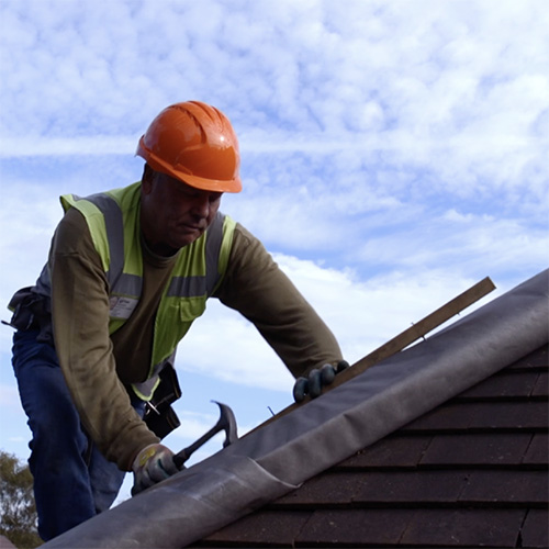 Roofer ttiles roof for promotional video produced by VideoHQ