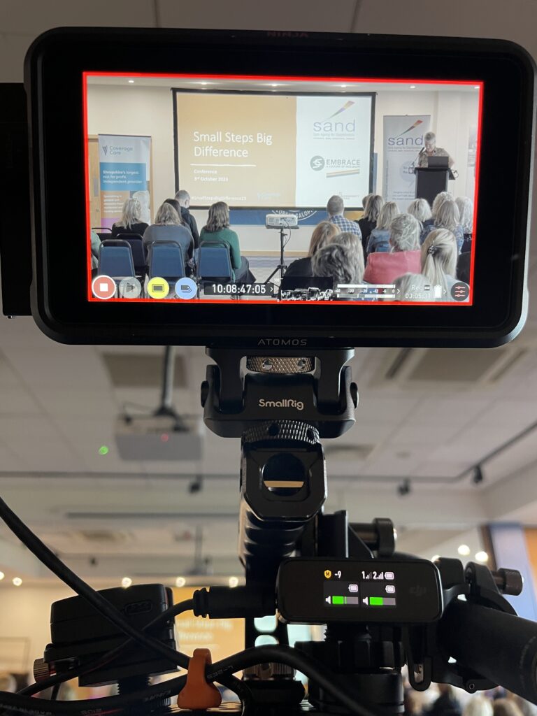 Image shows a camera monitor recording an LGBT conference at the Montgomery Waters Meadow stadium in Shrewsbury, Shropshire